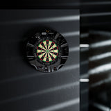 Dartboard with a black frame on a dark background Dartboard with a black frame on a dark background