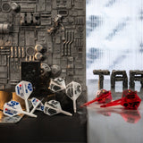 Darts with Star Wars-themed flight designs on a reflective surface with a textured wall background. Darts with Star Wars-themed flight designs on a reflective surface with a textured wall background.