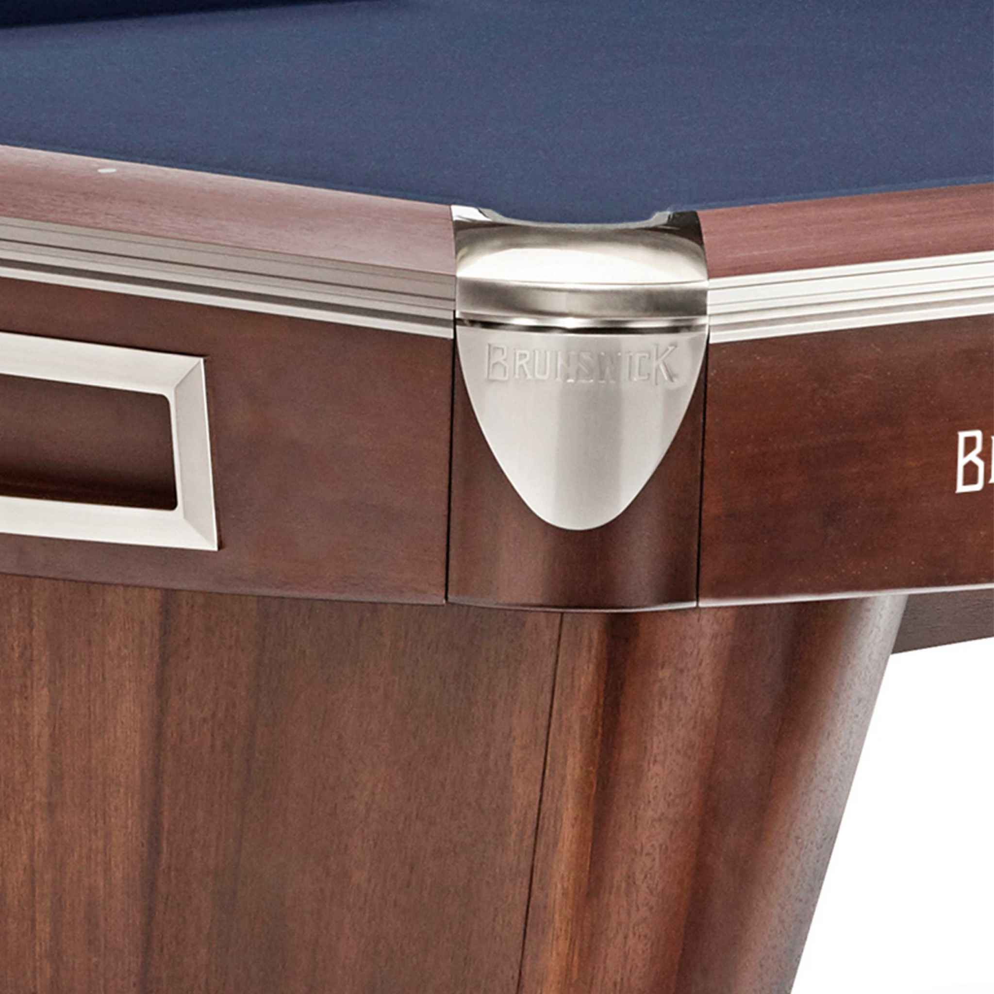 Close-up of Brunswick Gold Crown VI pool table corner with walnut finish and brushed nickel rail casting Close-up of Brunswick Gold Crown VI pool table corner with walnut finish and brushed nickel rail casting