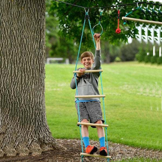 Boy climbing on Slackers Ninja Rope Ladder attached to a tree in a backyard playground