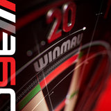 Close-up of a dartboard with 'Winmau' branding and a dart in the shot.