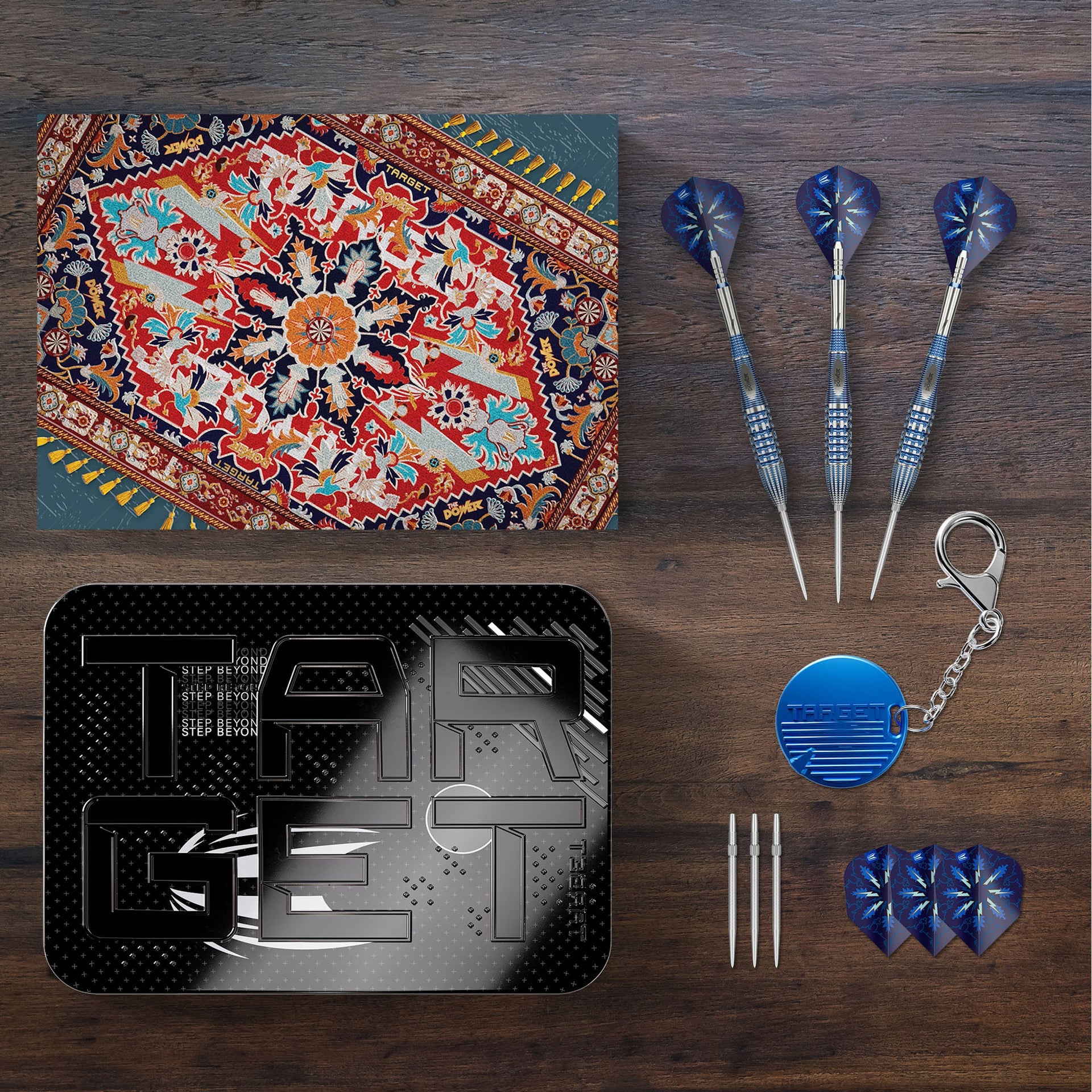 Collection of items including a dartboard, darts, and related accessories on a wooden surface.