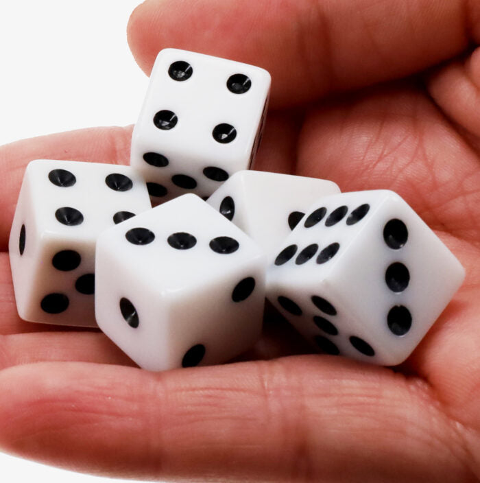 Liar's Dice + 10 Dice Games close up of dice in a hand.