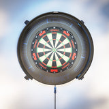 A circular Target dartboard with a black outer frame and a blue LED ring glow, shown against a soft, out-of-focus light blue and white background.