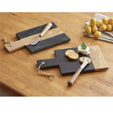 Slate and wood cutting board set with paddle design, jute rope detail, and wooden-handled metal spreaders on a wooden surface
