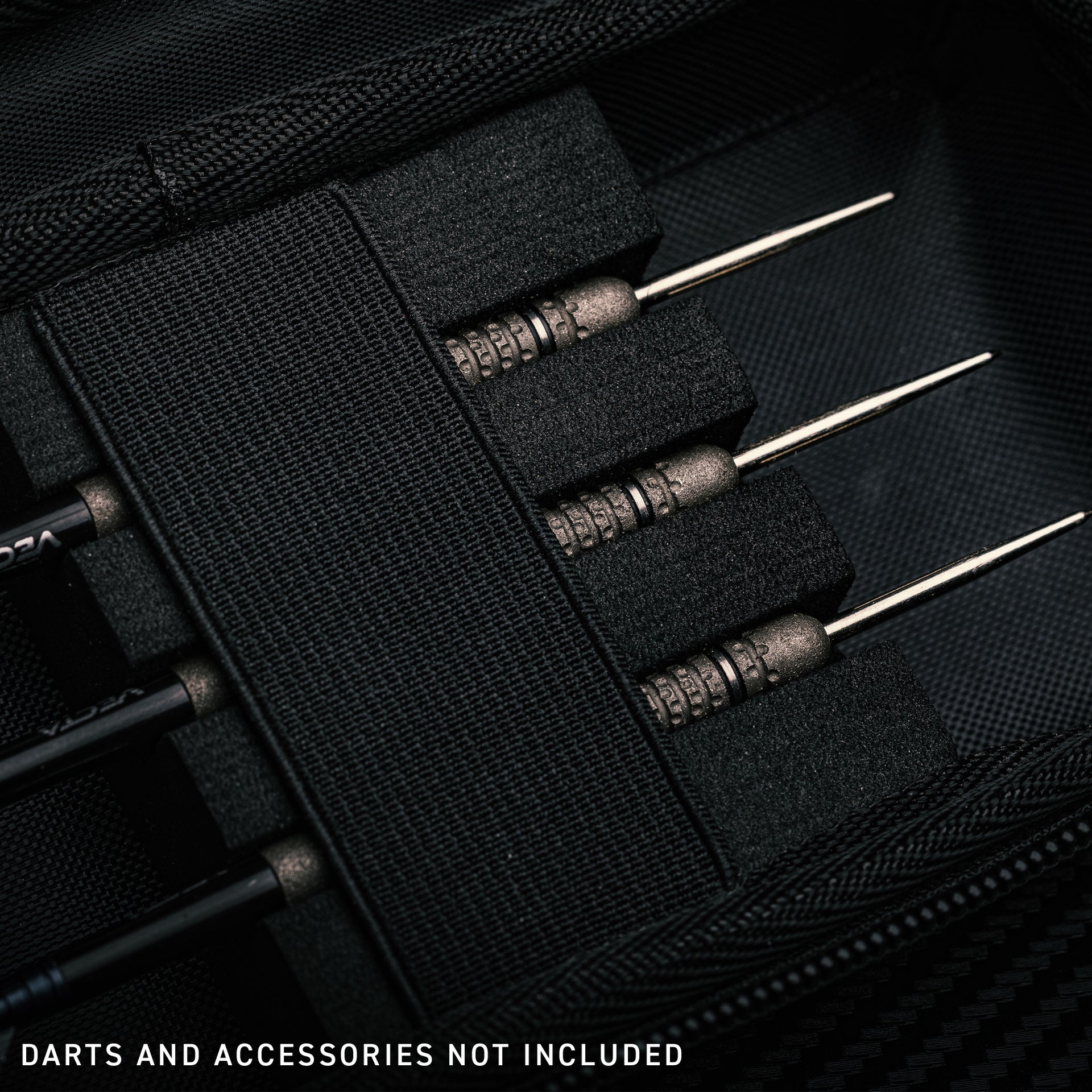 Close-up of black dart case with darts and accessories not included text
