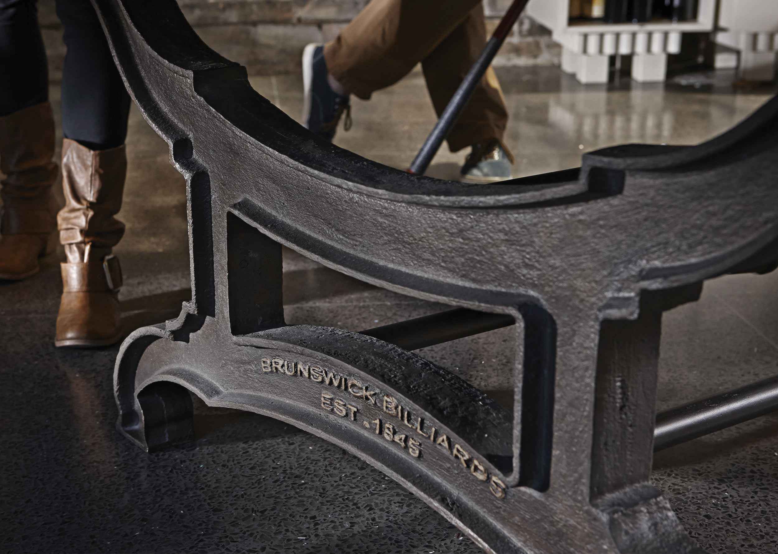 Close-up of the cast iron decorative pedestal base of the Birmingham Pool Table by Brunswick Billiards with vintage industrial design details