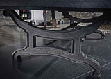Close-up of Birmingham Pool Table cast iron decorative pedestal with Brunswick Billiards engraving on polished concrete floor