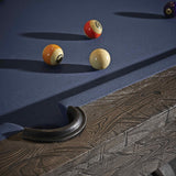 Close-up of Birmingham Pool Table with charcoal distressed wood finish, blue woolen cloth, and billiard balls on the playing surface
