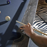 Birmingham Pool Table by Brunswick Billiards with distressed wood finish, charcoal woolen cloth, and hand-hammered rail sights shown in play angle
