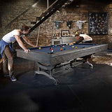 Birmingham Pool Table by Brunswick Billiards with distressed finish and cast iron pedestal in industrial loft game room setting