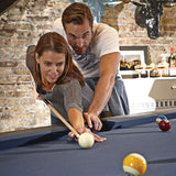 Couple playing on Birmingham Pool Table with charcoal finish in rustic industrial game room setting