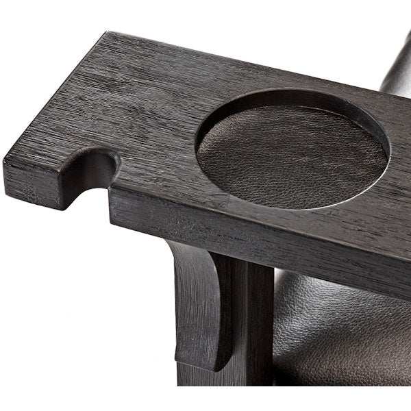 Close-up of Brunswick Centennial Player's Chair armrest with cue notch and cup holder in dark wood finish