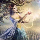 Woman in a fantasy dress holding a glowing object in a mystical forest setting