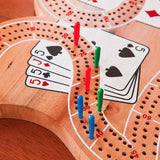 Wooden 29 Cribbage Board with plastic pegs and playing cards on a three-track game board