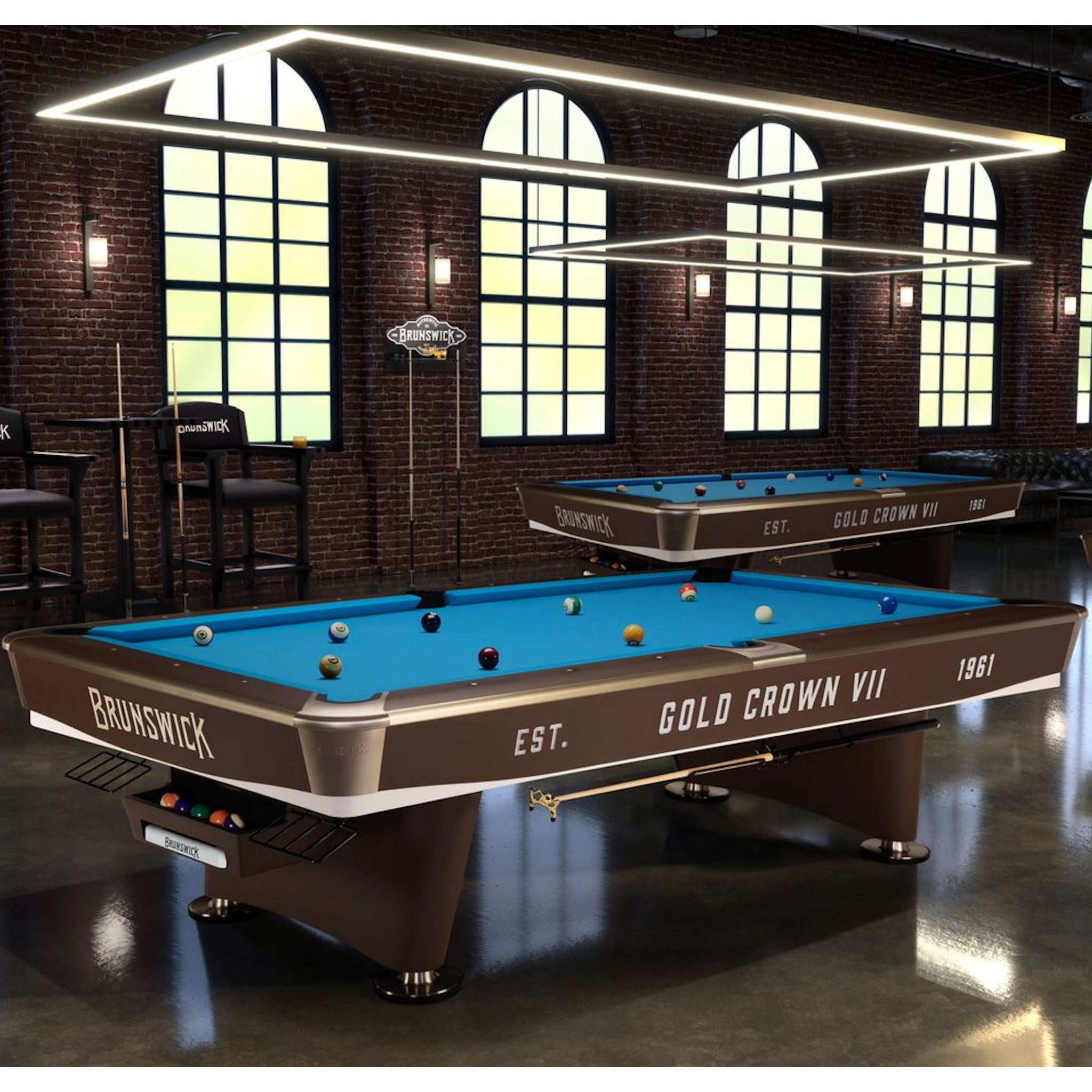 Pool table with Brunswick Gold Crown VII branding in a room with large windows and brick walls.