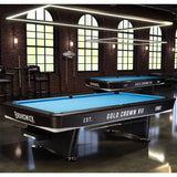 Brunswick Gold Crown VII pool table in a room with brick walls and large windows.