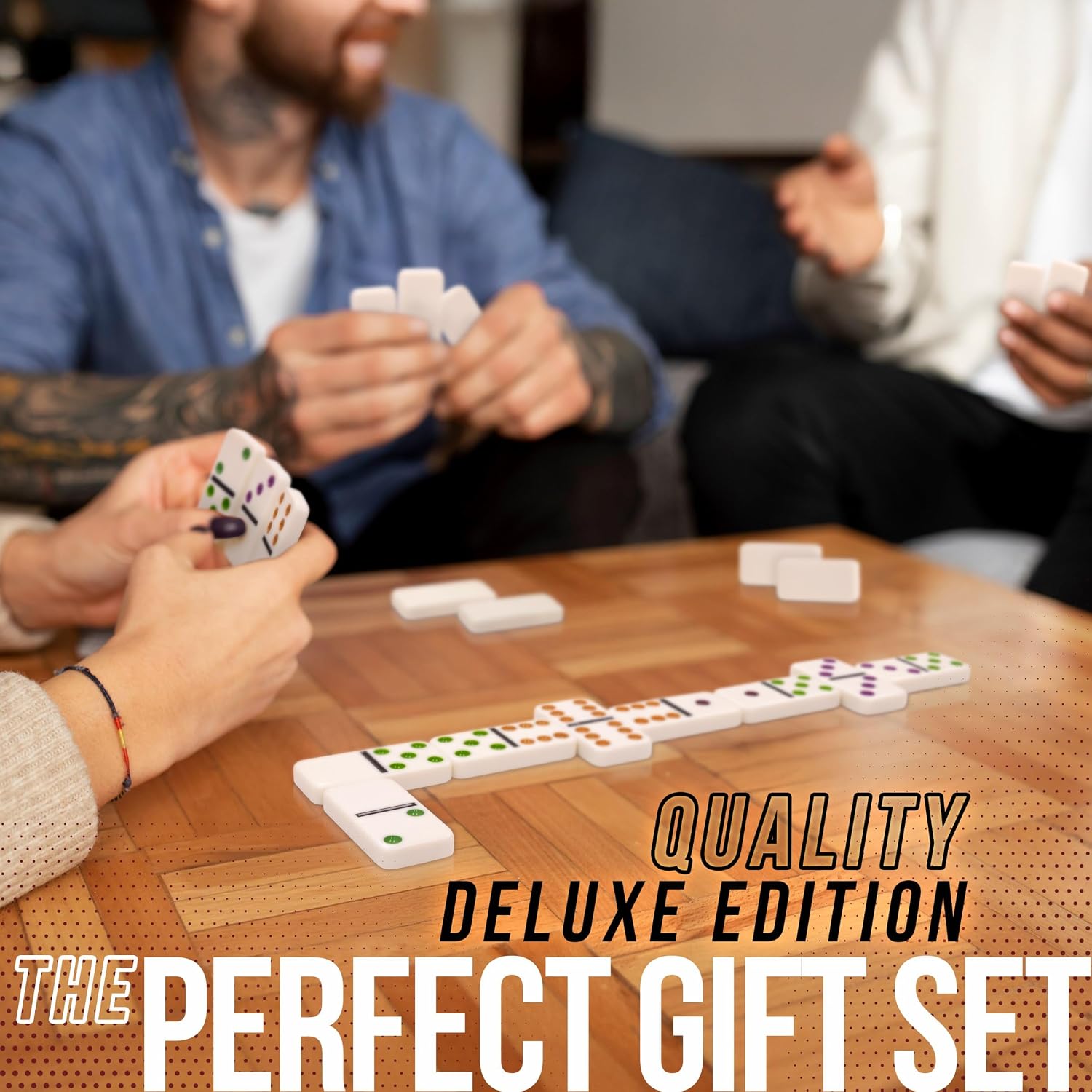 People playing a game with dominoes on a wooden table, text 'Quality Deluxe Edition The Perfect Gift Set' overlayed.