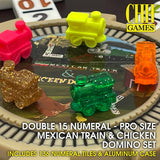 Mexican Train & Chicken Domino set with colorful train-shaped tiles in pink, yellow, green, orange, and gold glitter, displayed on a game board with text overlays.