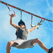 Boy using Slackers Ninjaline 36' Intro Kit outdoor hanging obstacle course with rings and grips against blue sky