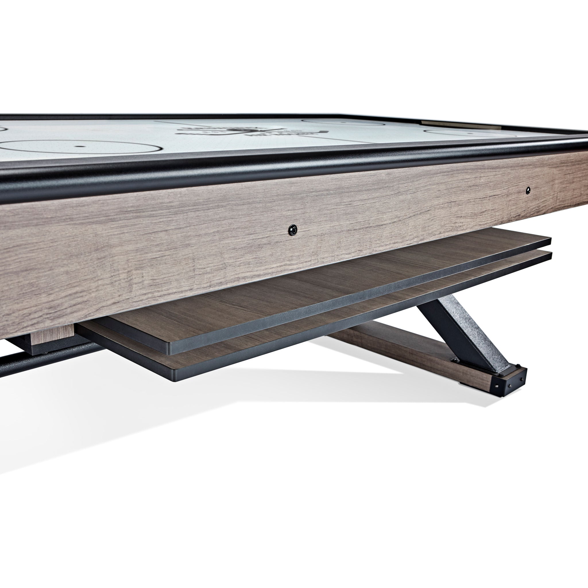 Close-up of a wooden air hockey table with a white playing surface.
