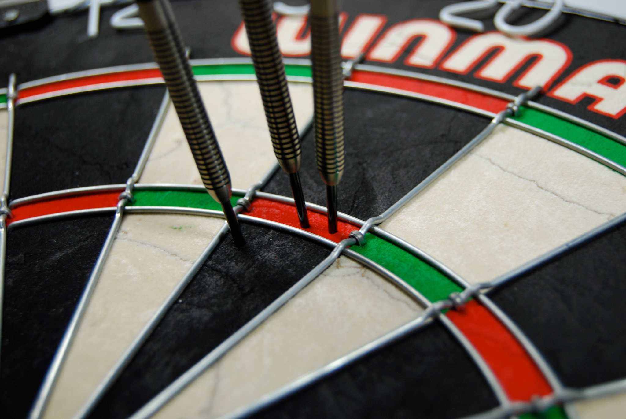 Close-up of Winmau Pro SFB Dartboard with three darts in the triple 20 segment