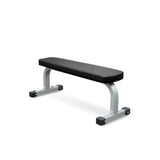 Impulse Flat Bench with wide base, designed for dumbbell and barbell exercises, featuring dual rear transport wheels for easy movement